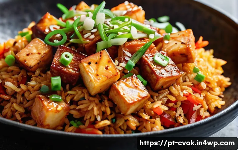 대체 단백질 요리법으로 만드는 김치 볶음밥 - **Vibrant Kimchi Fried Rice with Crispy Tofu:** A close-up, top-down shot of a beautifully plated Ki...